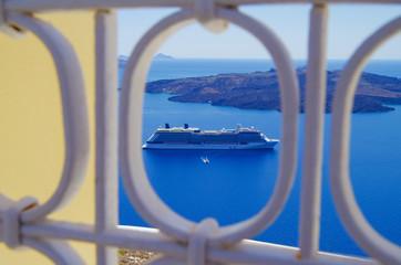 Modern luxury cruiseship or cruise ship liner with Santorin landscape and nature in panoramic view...