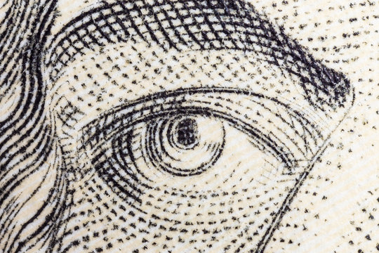 Macro close up photograph of Alexander Hamilton eye on the US ten dollar bill.