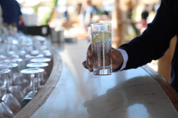 close up male hand is holding a glass of sparkling water