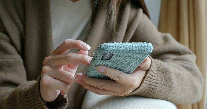 Woman touch on the phone at home