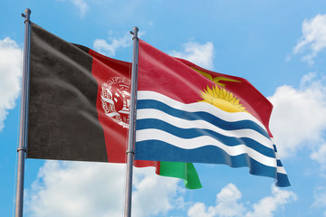 Kiribati and Afghanistan flags waving in the wind against white cloudy blue sky together. Diplomacy concept, international relations.