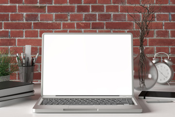 Workspace with blank laptop monitor white screen mock up on the white desk near red brick wall. 3d illustration