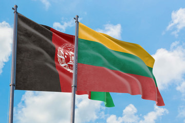 Lithuania and Afghanistan flags waving in the wind against white cloudy blue sky together. Diplomacy concept, international relations.