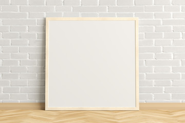 Blank square poster frame mock up standing on light herringbone parquet floor next to white brick wall. Clipping path around poster. 3d illustration