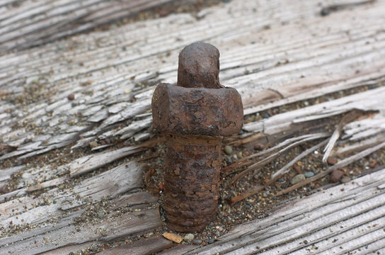 Rusting bolt and nut in weathered wood