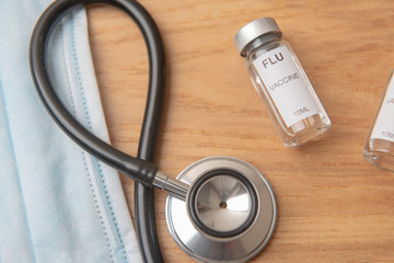 u vaccine with stethoscope on a wooden background 