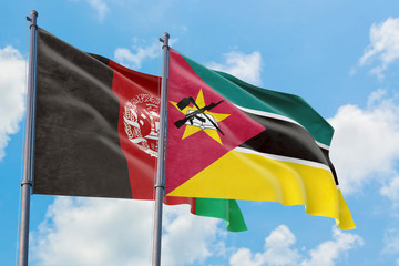 Fototapeta na wymiar Mozambique and Afghanistan flags waving in the wind against white cloudy blue sky together. Diplomacy concept, international relations.