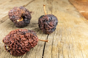 Shriveled apple. Old apple. Wrinkled apple texture. Dry skin. Old withered fruit.