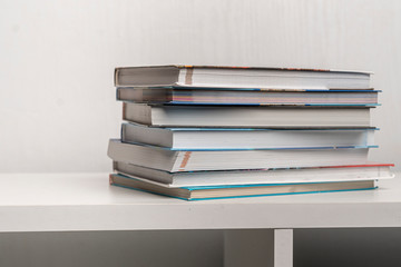a simple stack of books on the shelf at home