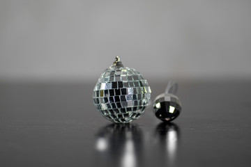 Mini disco ball on grey background. Shining party symbol