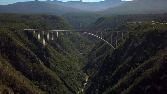 Huge Bloukrans Road Bridge Arching Over Valley & River, South Africa, Aerial Drone Backward Motion