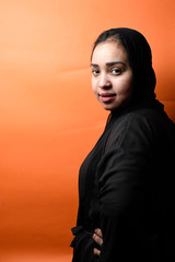 Portrait of arabic woman with traditional abaya dress in a studio