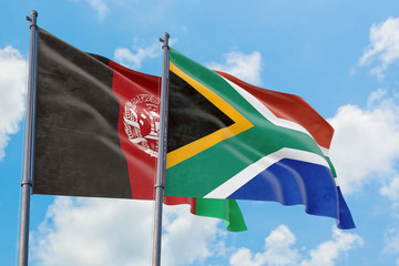 South Africa and Afghanistan flags waving in the wind against white cloudy blue sky together. Diplomacy concept, international relations.