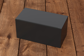 Blank black wide box with closed hinged flap lid on dark wooden background. Clipping path around box mock up. 3d illustration