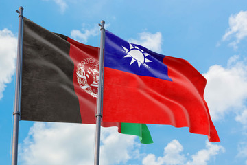 Taiwan and Afghanistan flags waving in the wind against white cloudy blue sky together. Diplomacy concept, international relations.