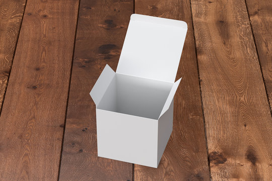 Blank white cube gift box with opened hinged flap lid on dark wooden background. Clipping path around box mock up. 3d illustration
