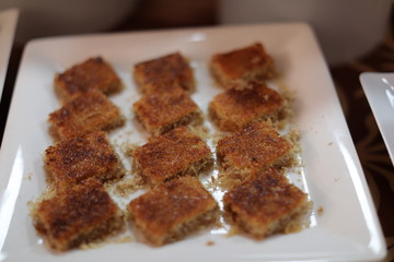 Close up of traditional oriental sweet pastry cookies known as backlava, Turkish desert with sugar, honey, walnuts and pistachio