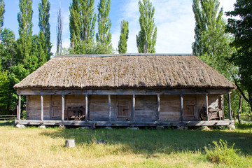 Fototapeta na wymiar An old warehouse structure made of wood with a thatched roof