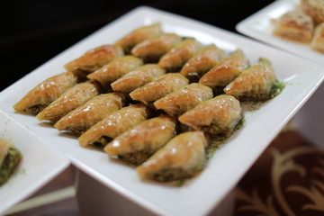 Close up of traditional oriental sweet pastry cookies known as backlava, Turkish desert with sugar, honey, walnuts and pistachio