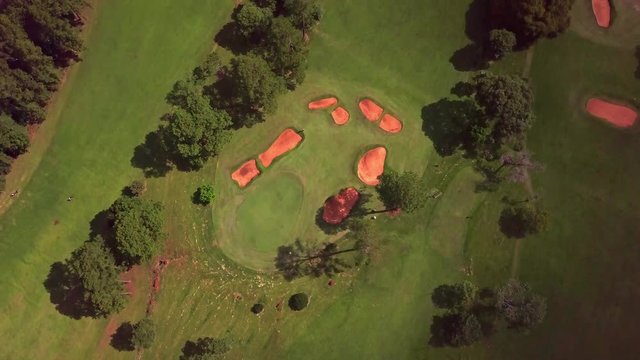 golf club Tacuru, argentina, south america. Air view, drone footage. Sunshine and shadows from clouds on the green and fairway. panoramic reveal pan up,