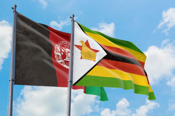 Zimbabwe and Afghanistan flags waving in the wind against white cloudy blue sky together. Diplomacy concept, international relations.