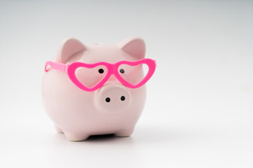 Piggy piggy bank in glasses in the shape of hearts, the concept of loving saving money