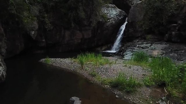 Las Garzas Waterfall, Charco El Ataud, Puerto Rico. Slow Motion Aerial View of Falling Freshwater
