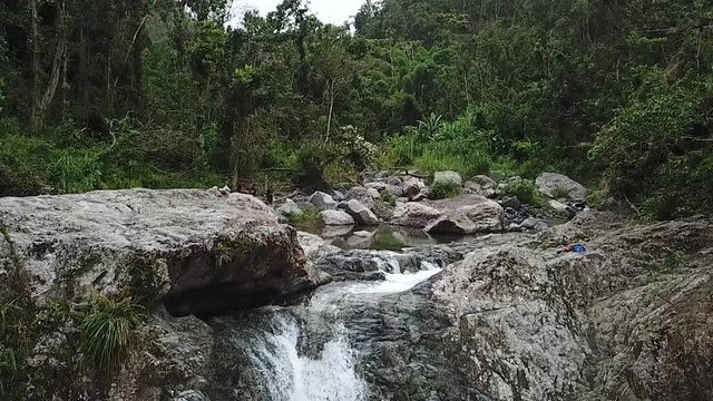 Rainforest, Creek and Waterfall, Slowmotion Aerial View. Charco El Ataud, Las Garzas, Puerto Rico