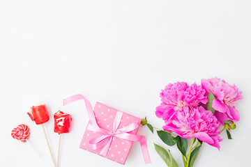 Flat lay valentines day frame with pink peonies and gift box on a white  background