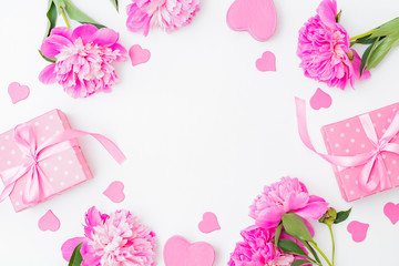 Flat lay valentines day frame with pink peonies and gift box on a white  background