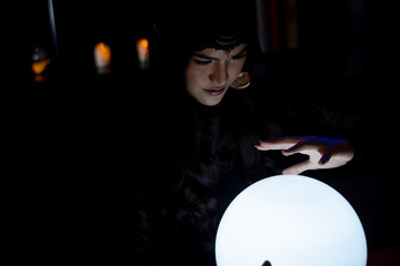 Fortune Teller's young Asian woman is predicting the future and destiny with crystal ball.