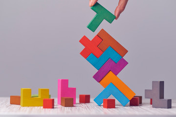 Hand arranging wood cube stacking as step stair. Business concept growth success process on blue background, copy space.