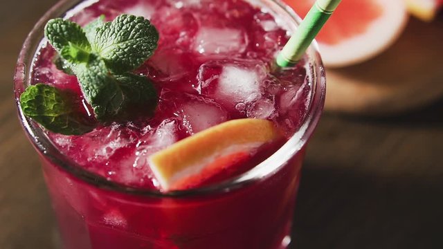 Cocktail with grapefruit, mint and ice, cran shot, close up.