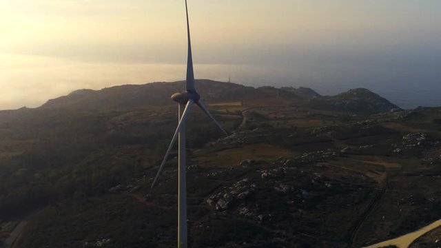 Aerial, drone shot, around a windmill, on the coast of Malpica, at sunrise, in A Coruna, Galicia, North Spain