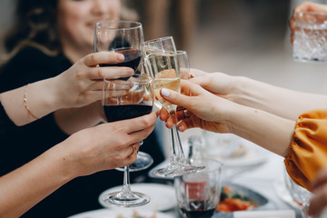 Cheers! Group of people cheering with champagne flutes with home interior in the background