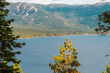 A red helicopter flies over Lake Tahoe near Crystal Bay