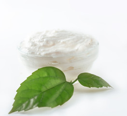 fresh  cream cheese and green leaf isolated on white
