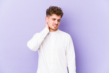 Young blond curly hair caucasian man isolated having a neck pain due to stress, massaging and touching it with hand.