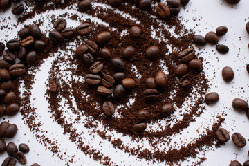 several scattered coffee beans on a white background