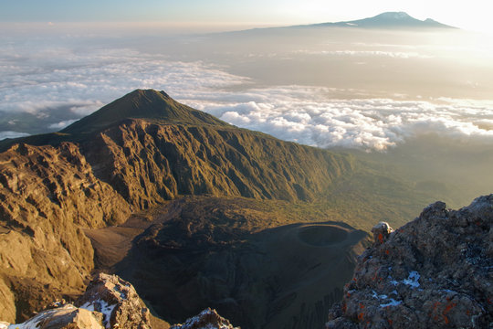 Mount Meru and its ash cone above clouds. Arusha  Tanzania. Africa. 