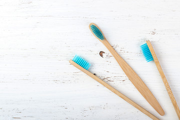 Eco friendly bamboo toothbrushes on wooden table background