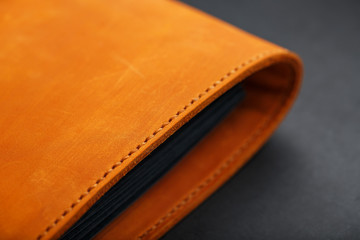 The album cover is made of brown genuine leather, handmade on a black background.