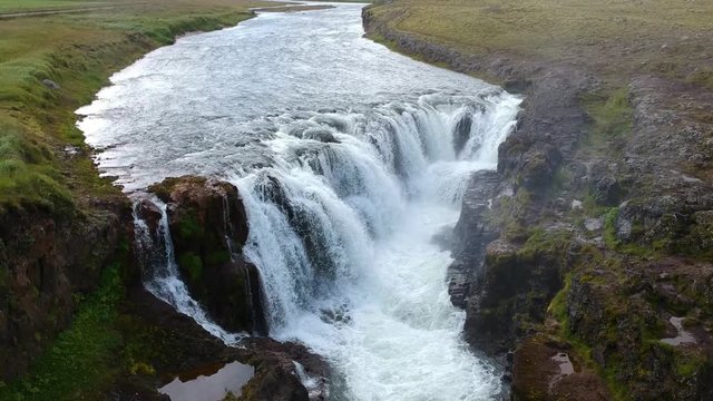 Droneshot of a waterfall called Kolugljufur in northern Iceland.