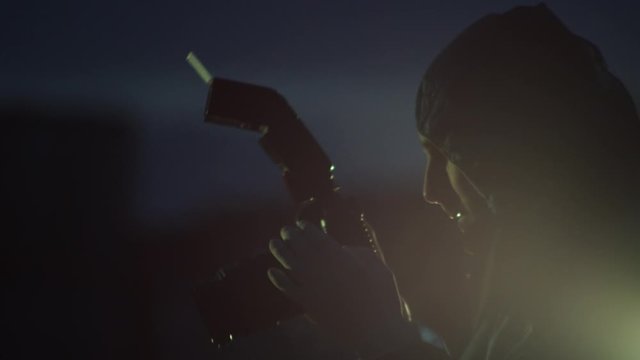 Criminal investigator taking photos of crime scene at night, light flares