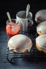 Homemade donuts ready to eat on dark table