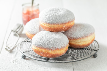 Brown donuts with white icing on white table