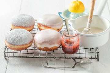 Fototapeta na wymiar Closeup of yummy and fresh donuts on cooling grate