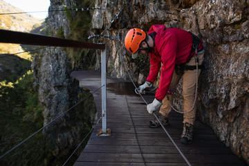 Caucasian man doing via ferrata