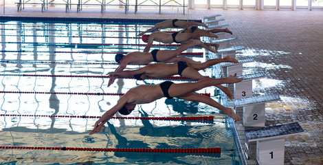 Swimmers plunging in the pool