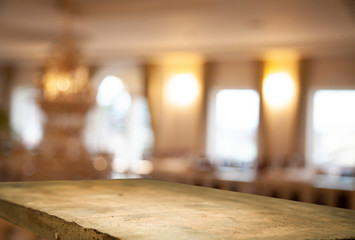 Empty wooden table top on blurred curtains overlooking office window, cafe, lady, green color with wood garden background. For mounting a product display (product) or visual design key.